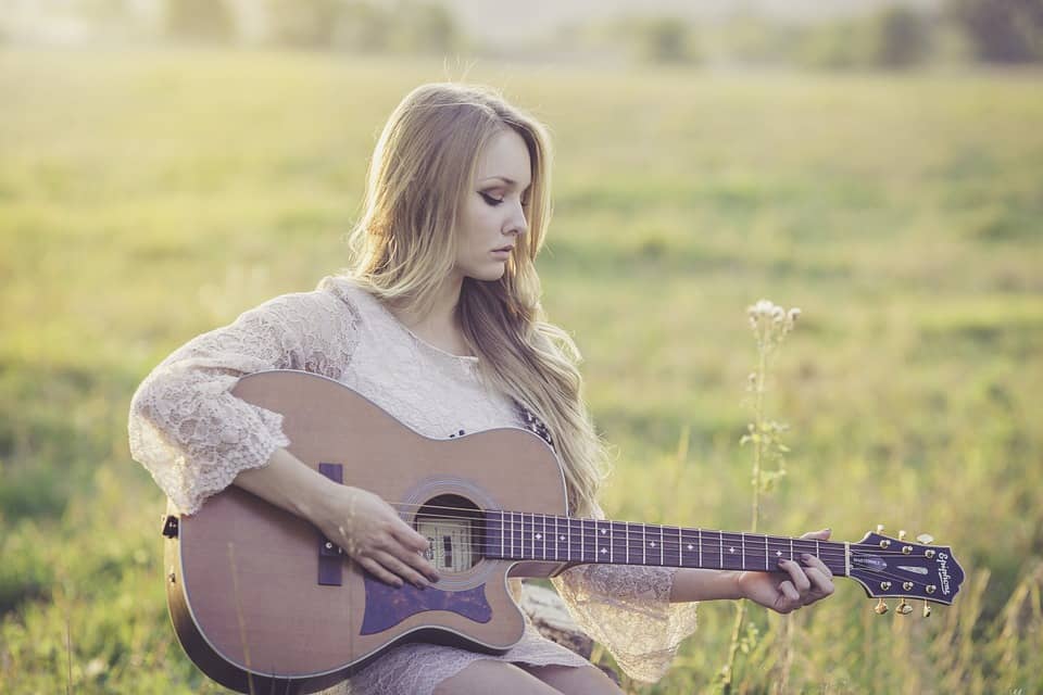 girl musician playing guitar